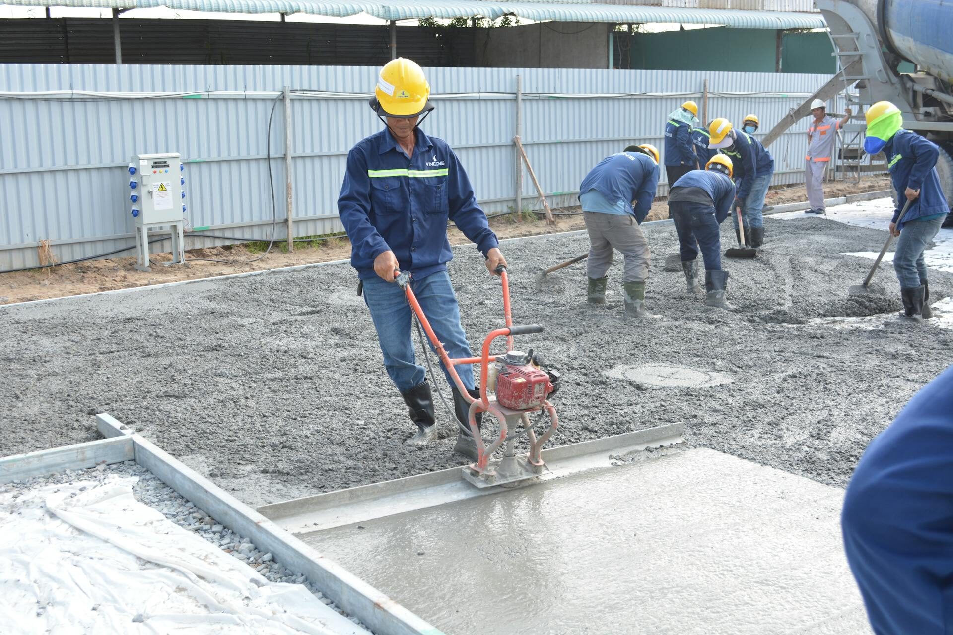 Concrete finisher smoothing a freshly placed slab